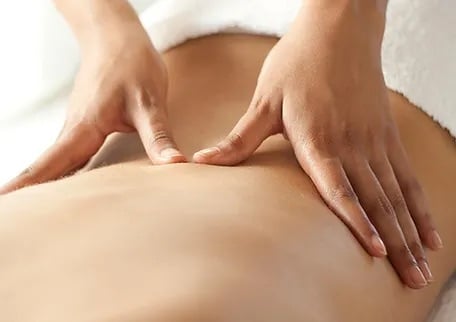 a chiropractor performing adjustment for the patients back