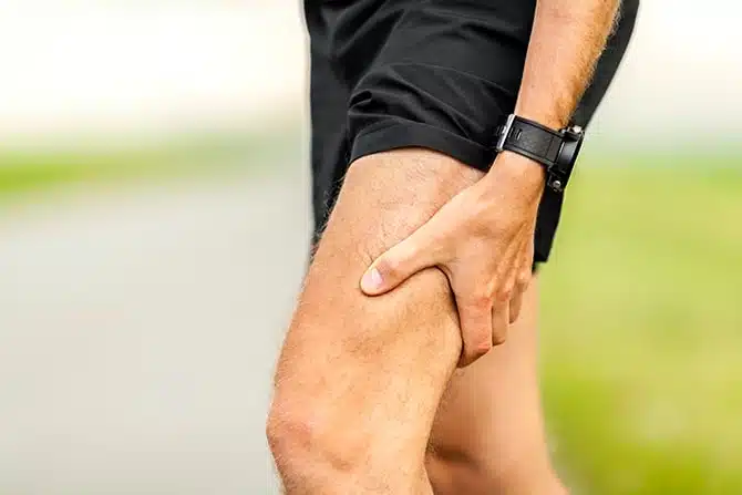 cropped shot of a runner's leg experiencing radiculopathy pain