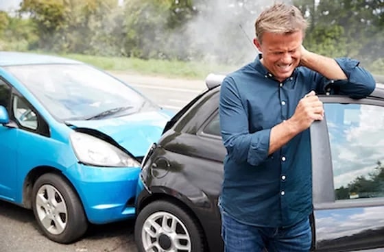 a man experiencing whiplash in a car crash accident