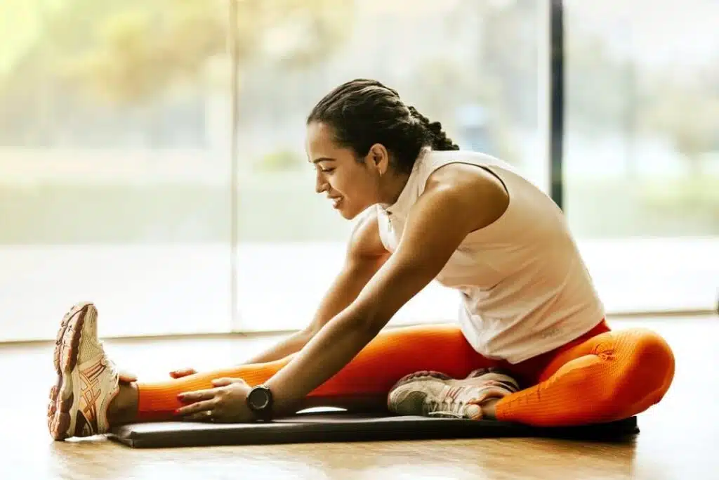 Woman is doing some stretching and exercise at home