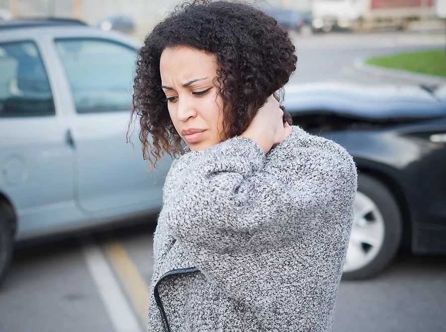 a woman experiencing whiplash