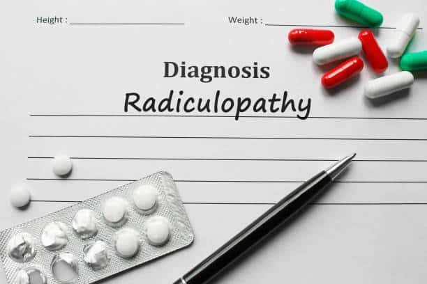 written radiculopathy medical diagnosis on a paper with pills and a pen