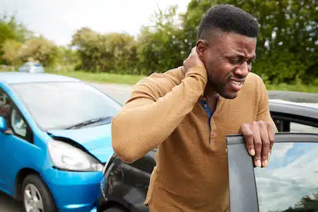 man involved in a car crash coming out of his car