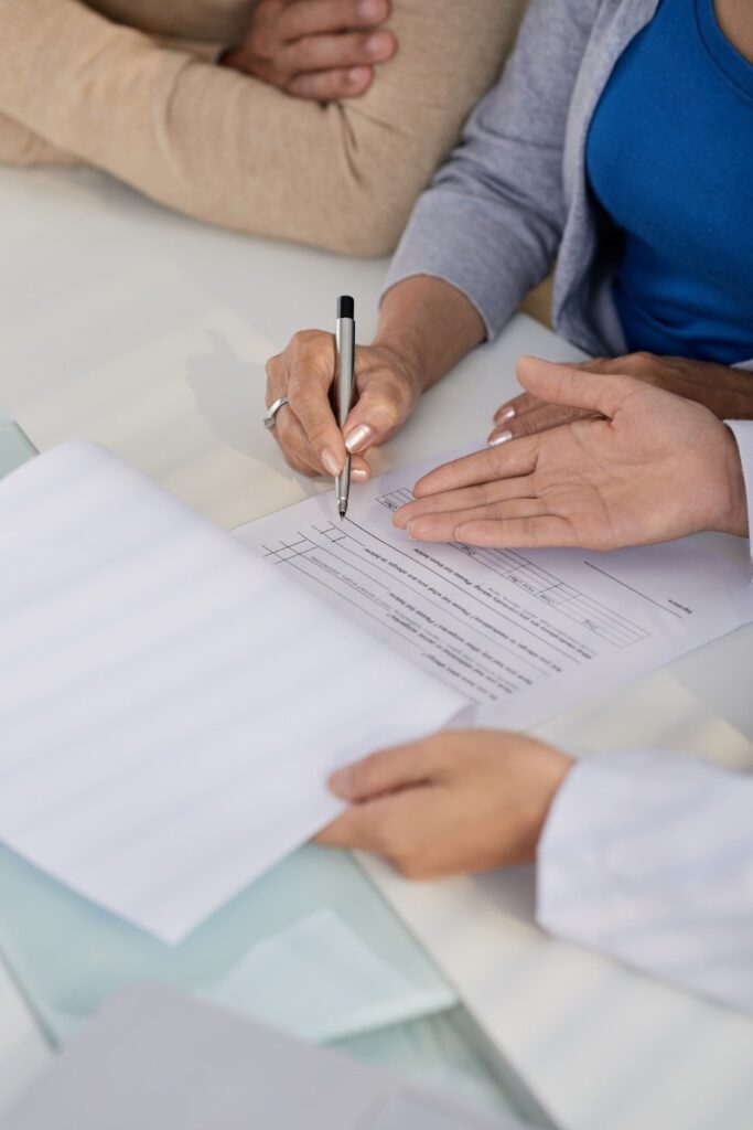 doctor showing patients medical paperwork 
