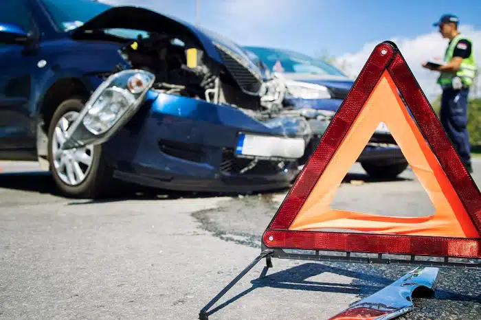 A car accident scene with damaged vehicles on the road.