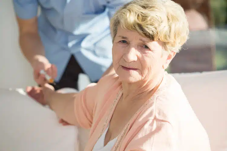 Elder woman receiving Platelet Rich Plasma Injection.