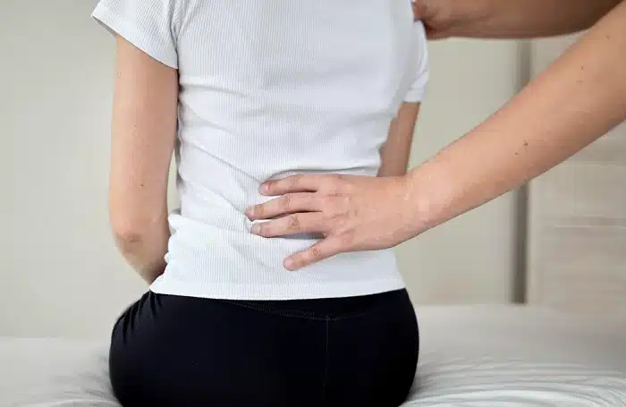 Chiropractor performing manual spinal adjustment for musculoskeletal pain relief