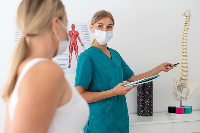 Chiropractor assessing patient's suitability for decompression