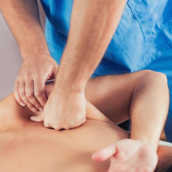a chiropractor performing an adjustment on a patient's back